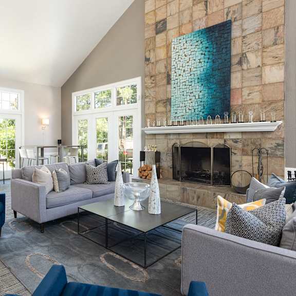 a living room with couches and chairs and a fireplace