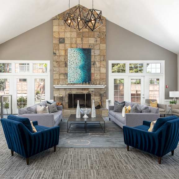 a living room with couches and chairs and a fireplace