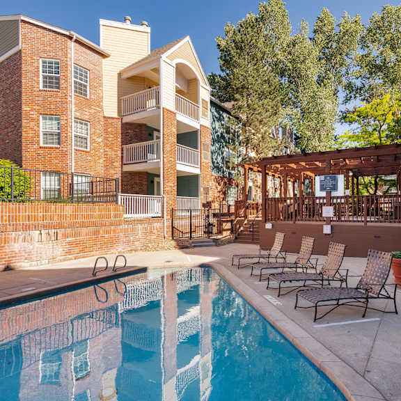 our apartments have a pool and a patio with chairs