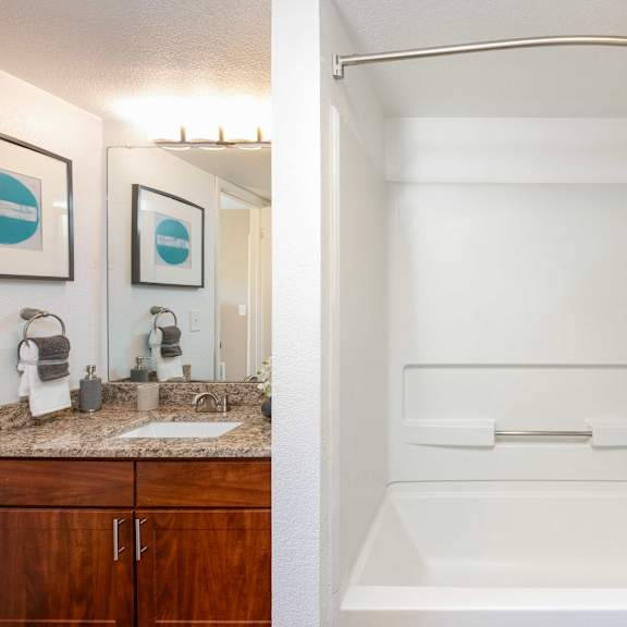 a bathroom with a shower and a sink and a bath tub