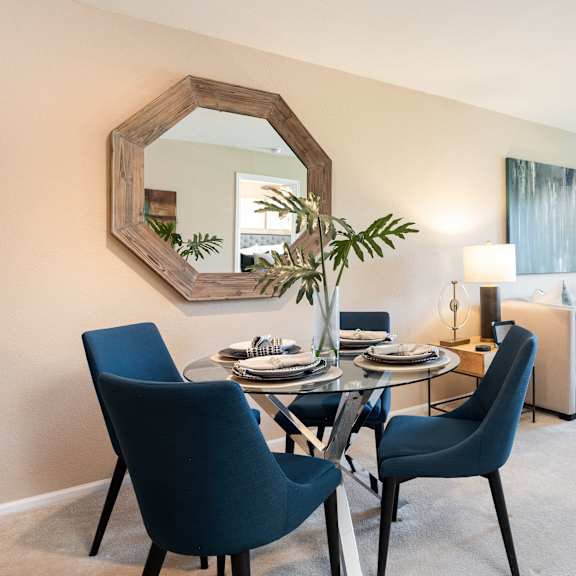 a living room with a dining room table and a couch