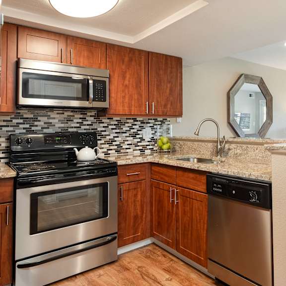 a kitchen with stainless steel appliances and a counter top