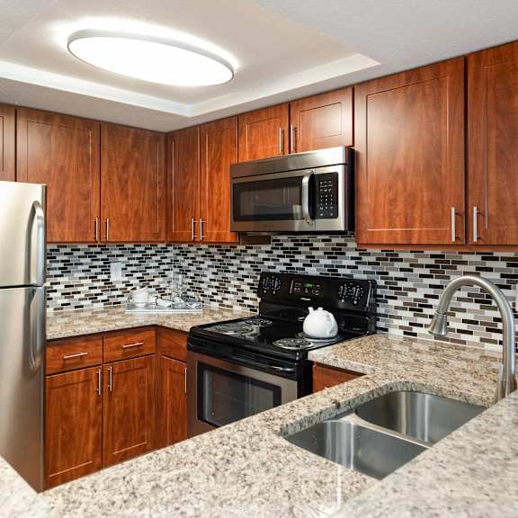 a kitchen with granite counter tops and stainless steel appliances