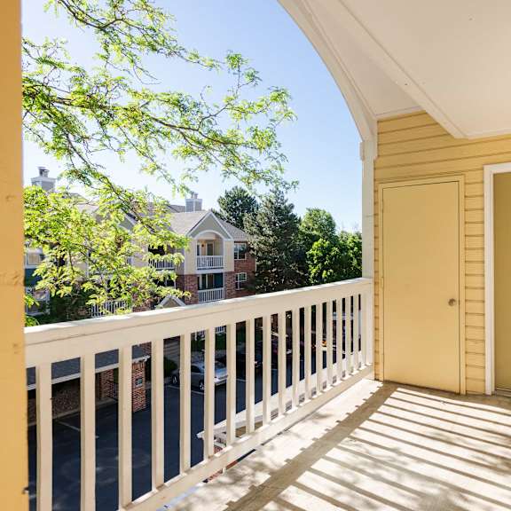 the front porch of a yellow house with a yellow door