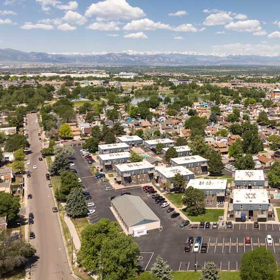 an aerial view of a suburb of a city with a road and cars