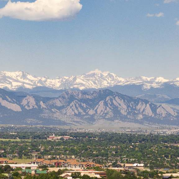 a view of the mountains in the distance with a city in the foreground