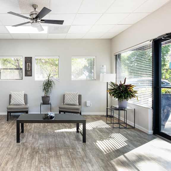 the preserve at ballantyne commons community room with seating and a ceiling fan