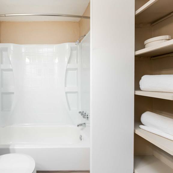 a bathroom with a shower and a toilet and a sink