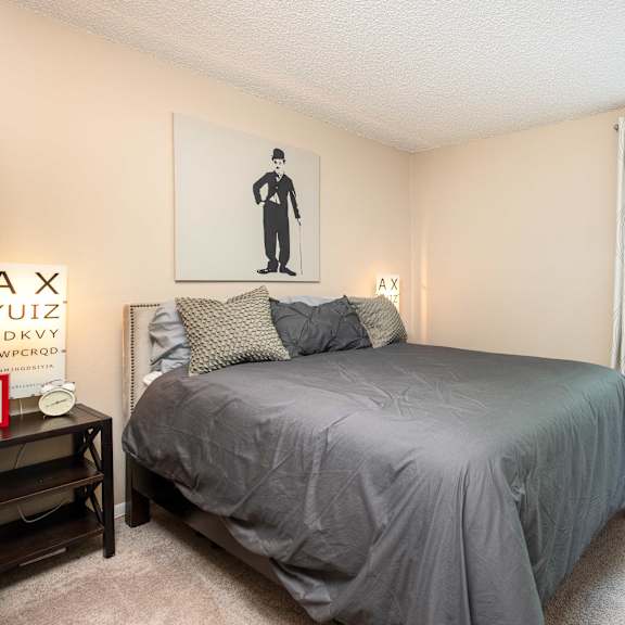a bedroom with a bed and a large window