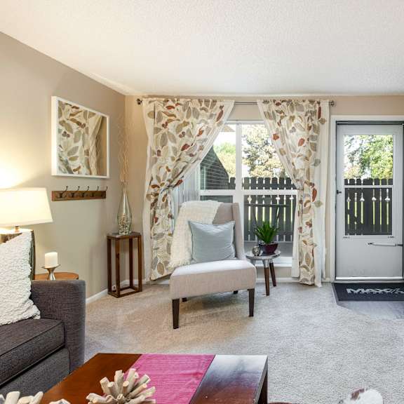 an open living room with a door to a balcony