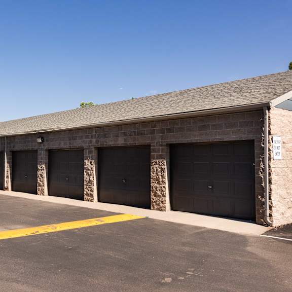 the outside of a building with garages and a parking lot