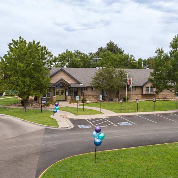 a view of the front of a house with a street and parking lot