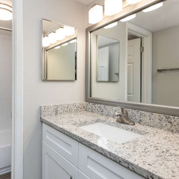 a bathroom with a white tub and sink.