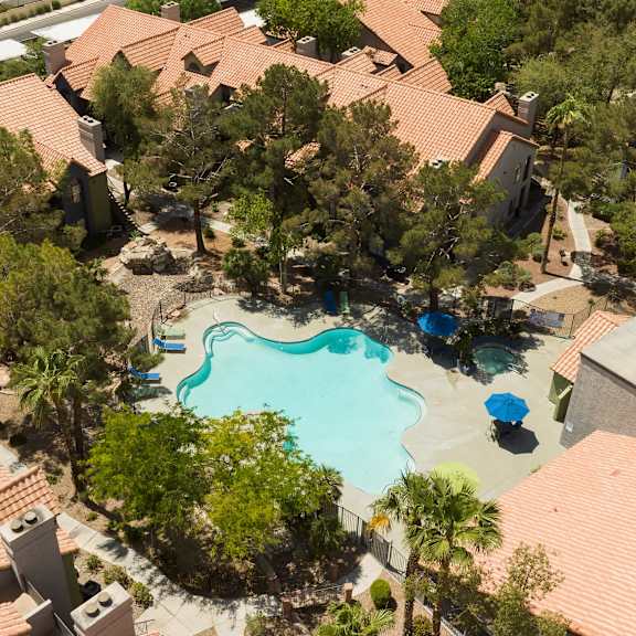 an aerial view of a swimming pool surrounded by houses