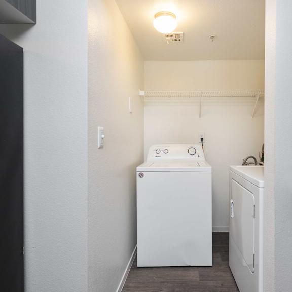 a small laundry room with a washer and dryer and a white washer