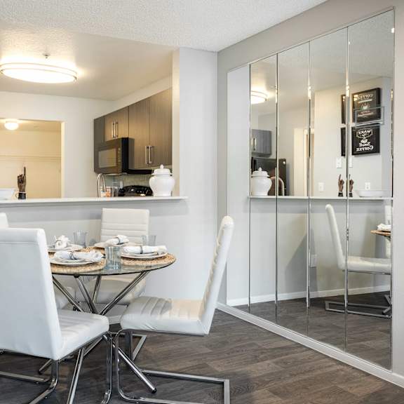 a dining room with a table and chairs and a kitchen