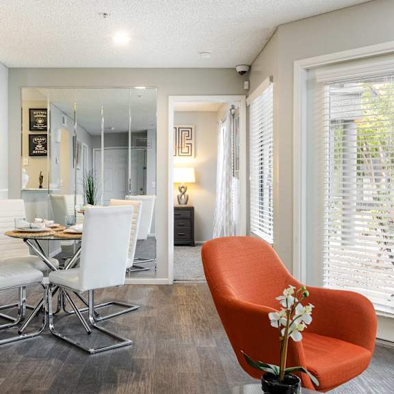 a living room and dining room with a table and chairs