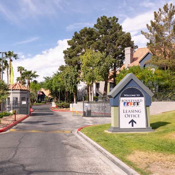 an empty street with a sign for a lease office at the end of a road