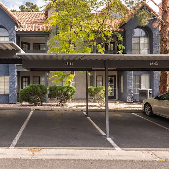 a parking lot with cars parked in front of a building