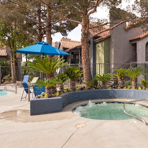 a hot tub in a pool in front of a house