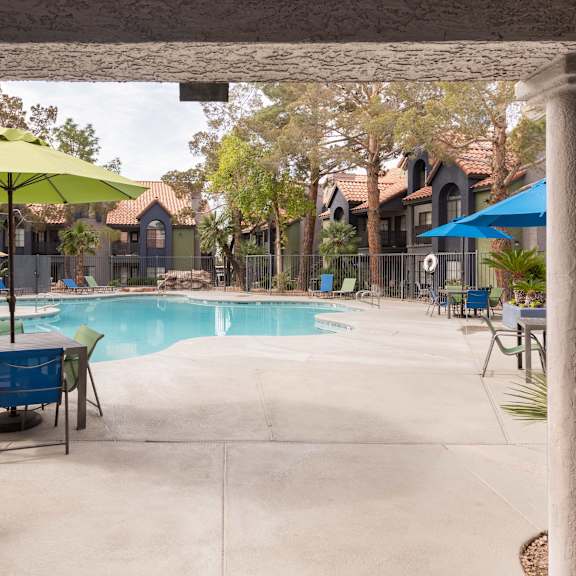 our apartments have a swimming pool with tables and umbrellas