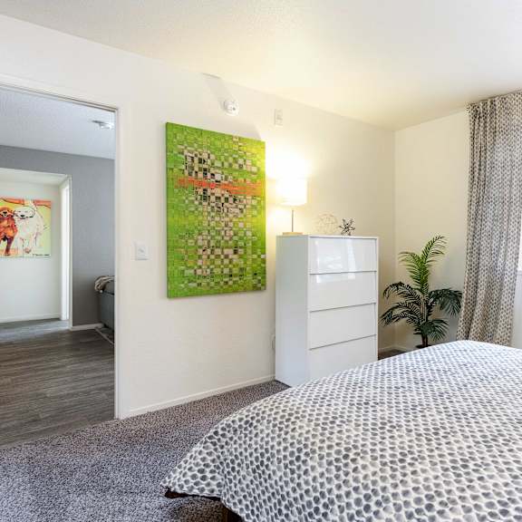 a bedroom with a bed and a window and a dresser