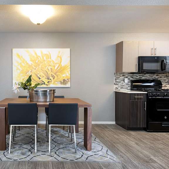 a dining room with a table and chairs and a kitchen