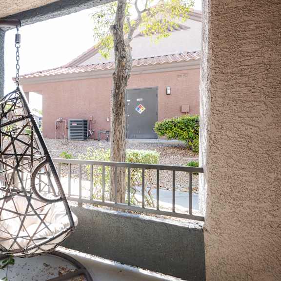 a hanging chair in front of a window
