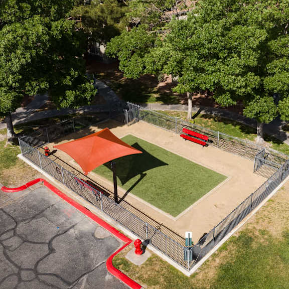 an aerial view of a park with a basketball court and a red court