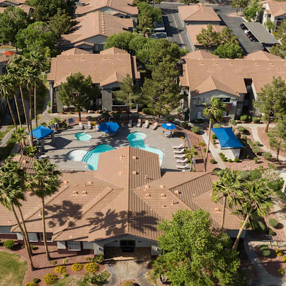 an aerial view of a neighborhood with houses and a swimming pool