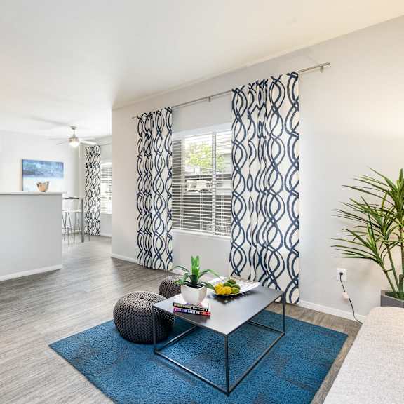 a living room with a table and a kitchen