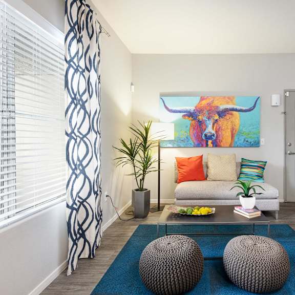 a living room with a couch and a painting of a bull