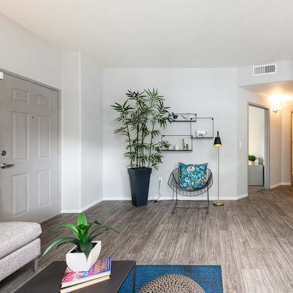 a living room with a couch and a chair and a plant