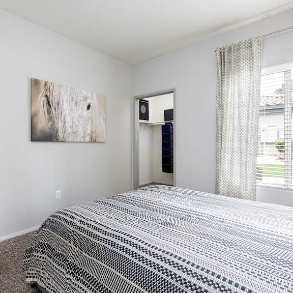 a bedroom with a bed and a window and a closet