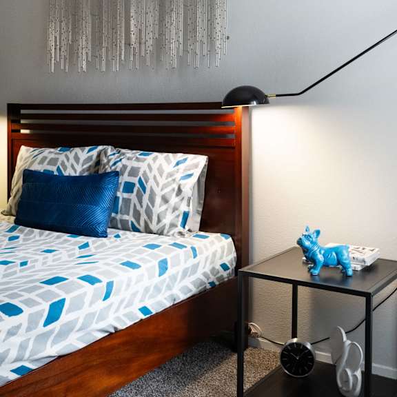 a small bedroom with a bed and a night stand