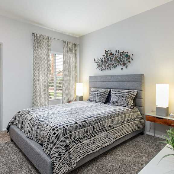 a bedroom with a bed and a window and a closet