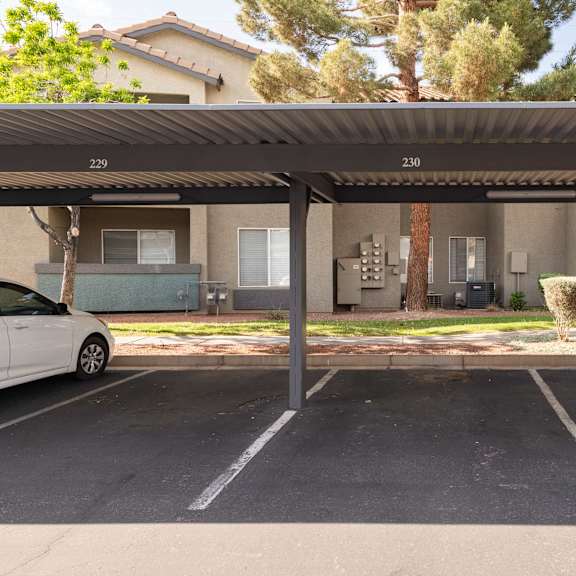 a parking lot with cars parked in front of a building