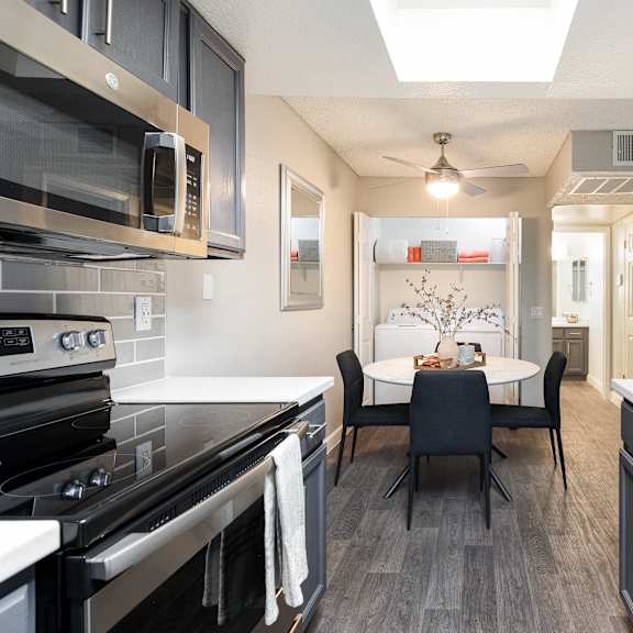 a kitchen and dining room with a table and chairs
