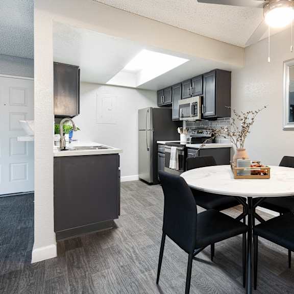 an open kitchen and dining area with a table and chairs