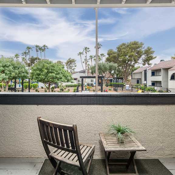 a picture of a patio with a chair and table