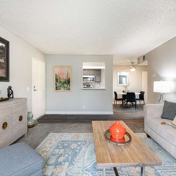 a living room with couches and chairs and a floor lamp
