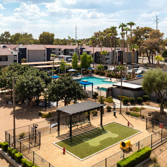 an aerial view of a park with a tennis court and a pool