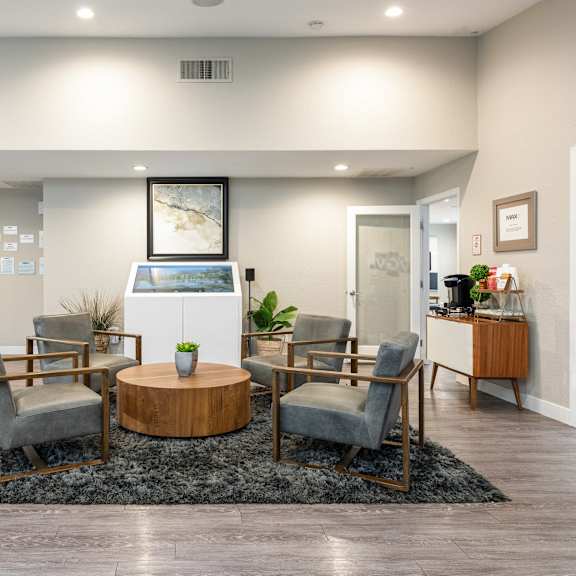 a living room with a table and chairs