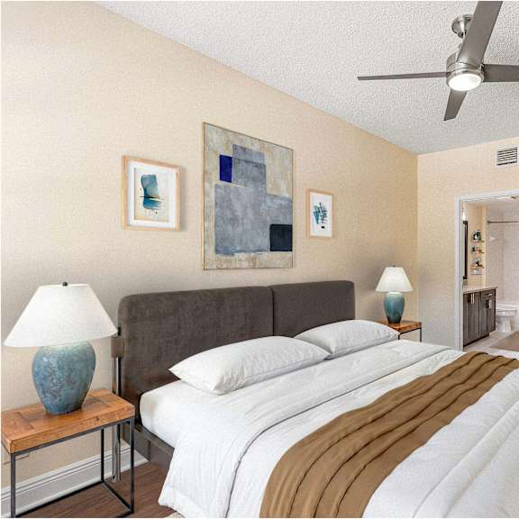 a bedroom with a bed, two lamps, and a painting on the wall.
