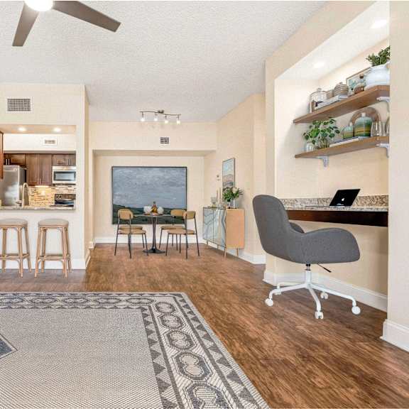 a living room with a couch, a chair, and a rug.