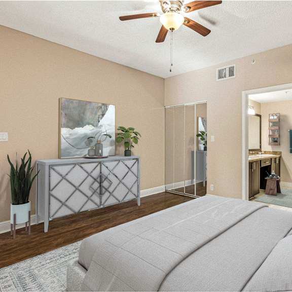 a bedroom with a large bed and a ceiling fan.