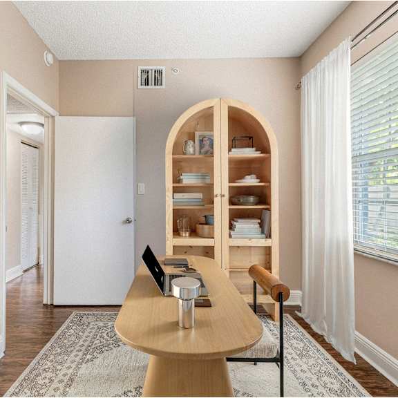 a dining room with a wooden table and chairs.