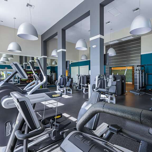 a gym with treadmills and exercise equipment.