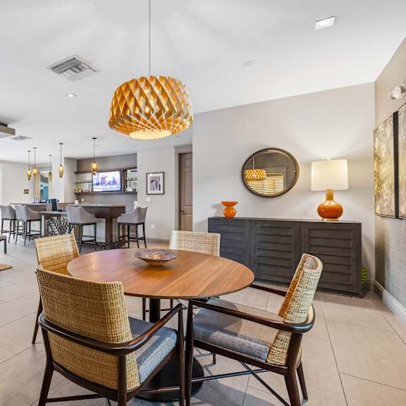 a modern dining room with a round wooden table and chairs.