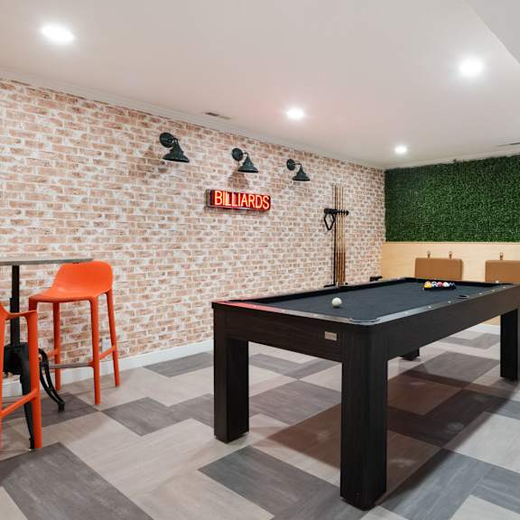 a game room with a pool table and a bar